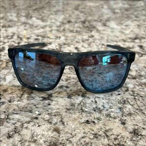 Oakley Blue Tinted Sunglasses.  Great sporty look and fit.  Very light.